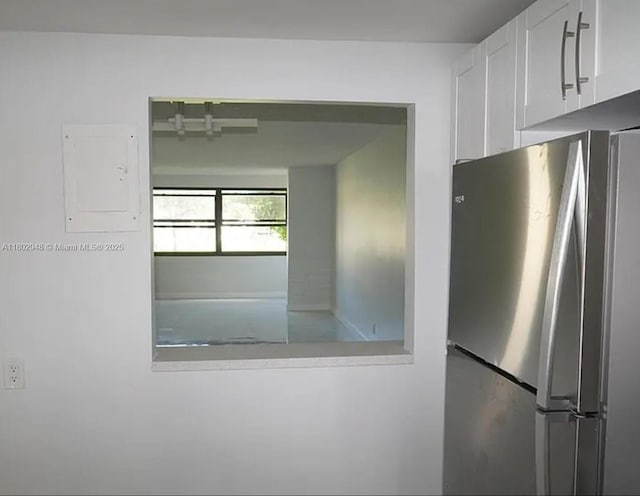 691 S Hollybrook Dr Unit 208, Pembroke Pines, FL 33025 - kitchen with freestanding refrigerator, white cabinetry, and electric panel