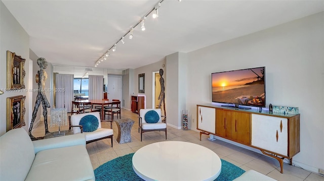 1500 S Ocean Dr Unit 12H, Hollywood, FL 33019 - living room featuring rail lighting, baseboards, and light tile patterned floors