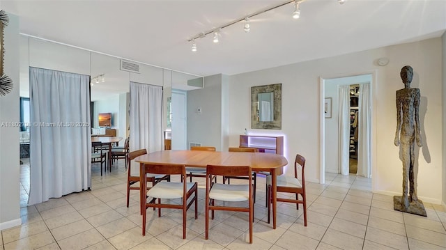 1500 S Ocean Dr Unit 12H, Hollywood, FL 33019 - dining area featuring light tile patterned floors, track lighting, and baseboards