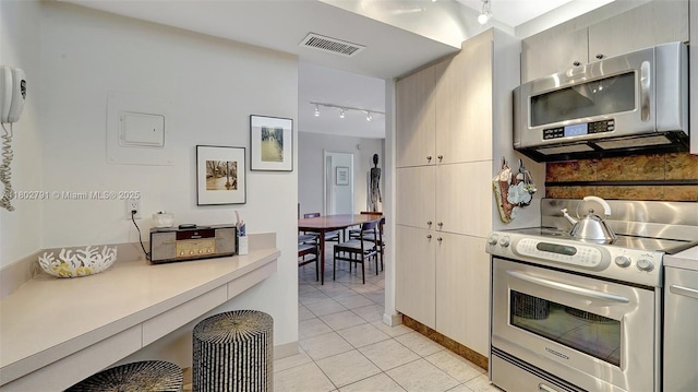 1500 S Ocean Dr Unit 12H, Hollywood, FL 33019 - kitchen featuring stainless steel appliances, track lighting, light tile patterned floors, and light countertops