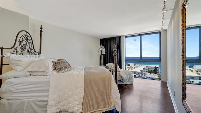 1500 S Ocean Dr Unit 12H, Hollywood, FL 33019 - bedroom featuring wood finished floors, track lighting, multiple windows, a water view, and floor to ceiling windows