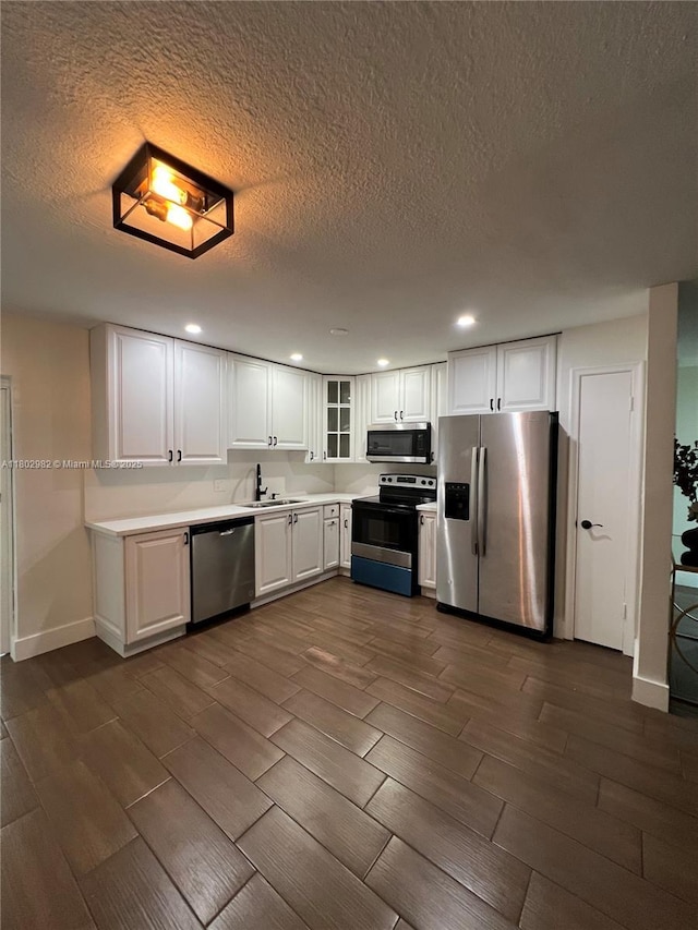 6391 SW 8th St, North Lauderdale, FL 33068 - kitchen with appliances with stainless steel finishes, wood tiled floors, recessed lighting, a textured ceiling, and a sink