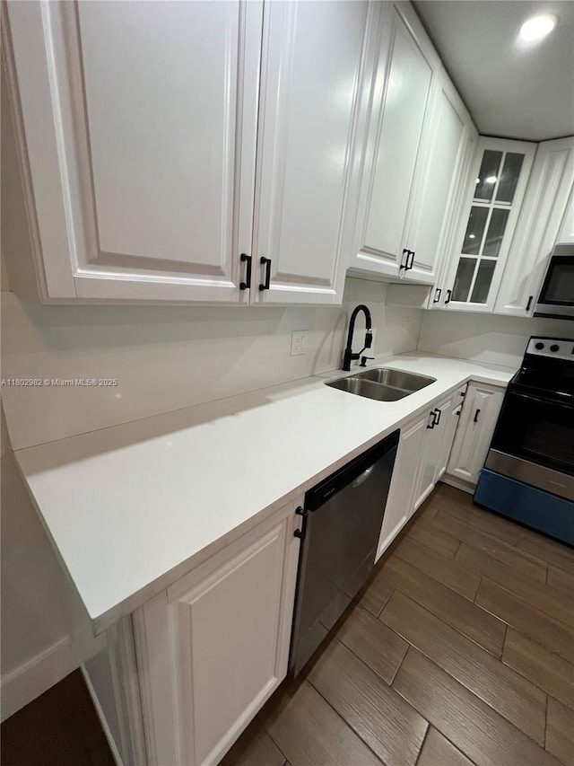 6391 SW 8th St, North Lauderdale, FL 33068 - kitchen featuring stainless steel appliances, a sink, white cabinetry, wood finish floors, and glass insert cabinets