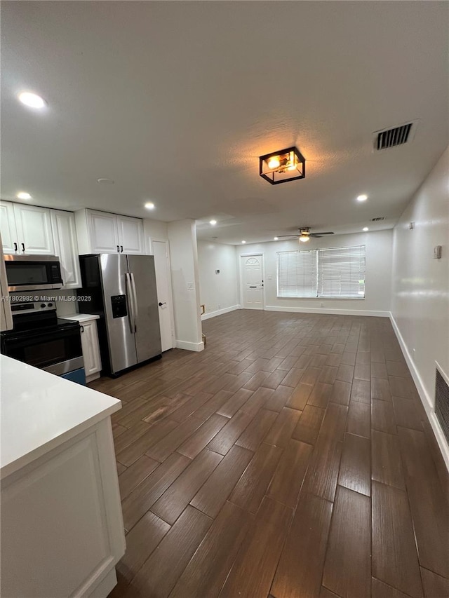 6391 SW 8th St, North Lauderdale, FL 33068 - kitchen featuring stainless steel appliances, wood finish floors, baseboards, white cabinets, and recessed lighting