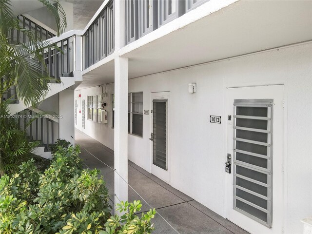 1012 Berkshire A 1012, Deerfield Beach, FL 33442 - view of exterior entry with stucco siding