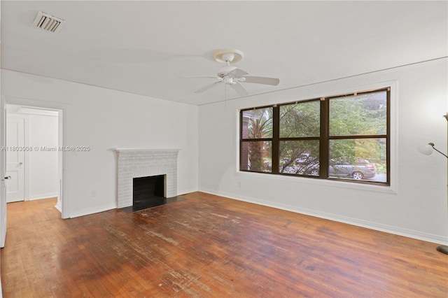 2196 Traymore Rd, Jacksonville, FL 32207 - unfurnished living room with wood finished floors, a ceiling fan, baseboards, and a brick fireplace