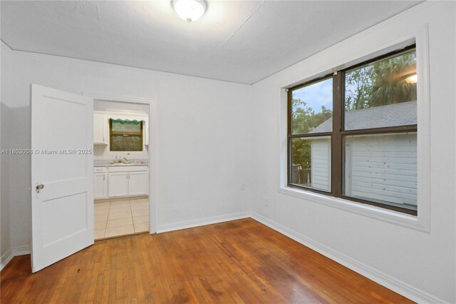 2196 Traymore Rd, Jacksonville, FL 32207 - unfurnished bedroom with hardwood / wood-style floors, baseboards, and connected bathroom