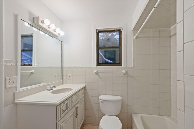 2196 Traymore Rd, Jacksonville, FL 32207 - full bathroom with tile walls, toilet, vanity,  shower combination, and wainscoting