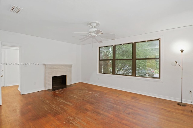 2196 Traymore Rd, Jacksonville, FL 32207 - unfurnished living room with a ceiling fan, wood finished floors, baseboards, and a brick fireplace
