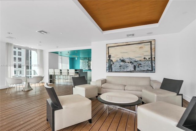 500 Brickell Ave Unit 2203, Miami, FL 33131 - living room with wood finished floors, a tray ceiling, and baseboards