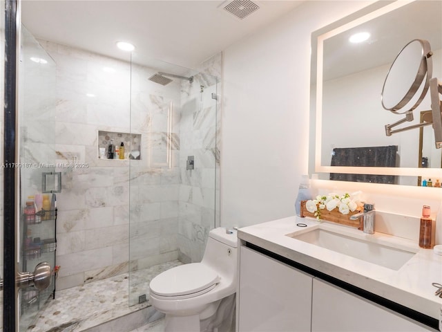 bathroom featuring toilet, a marble finish shower, vanity, and recessed lighting