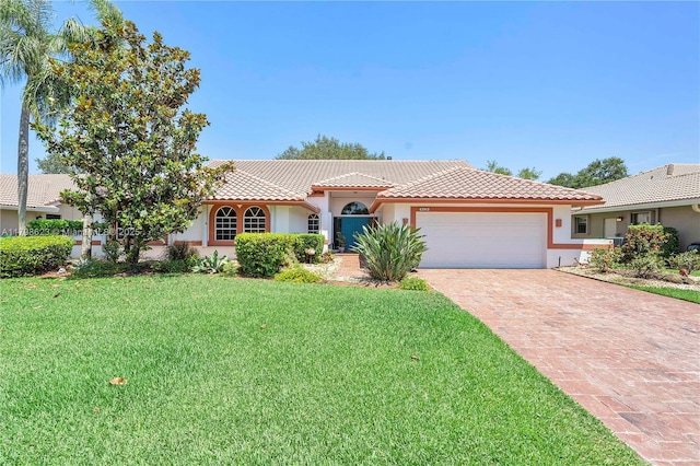 5425 NW 86th Ter, Coral Springs, FL 33067 - mediterranean / spanish-style home with a garage, a tiled roof, stucco siding, decorative driveway, and a front lawn