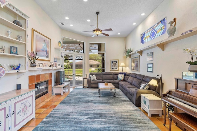 5425 NW 86th Ter, Coral Springs, FL 33067 - living room with ceiling fan, a textured ceiling, recessed lighting, a tiled fireplace, and french doors