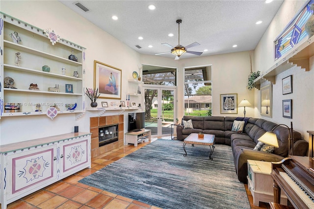 5425 NW 86th Ter, Coral Springs, FL 33067 - living room featuring ceiling fan, a textured ceiling, recessed lighting, french doors, and a fireplace