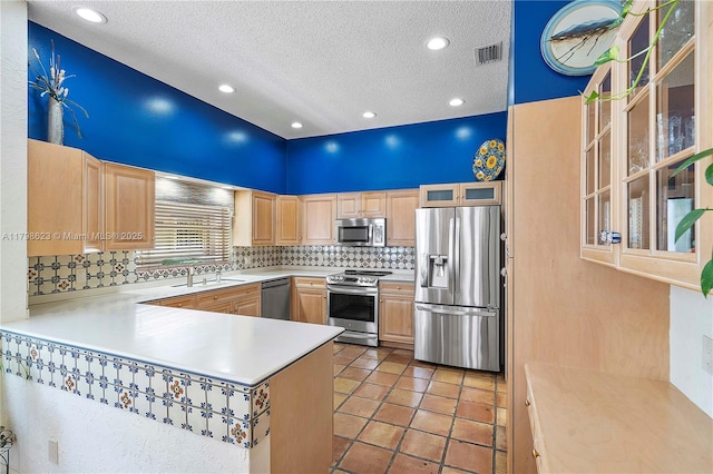 5425 NW 86th Ter, Coral Springs, FL 33067 - kitchen featuring stainless steel appliances, light brown cabinetry, a textured ceiling, backsplash, and light countertops