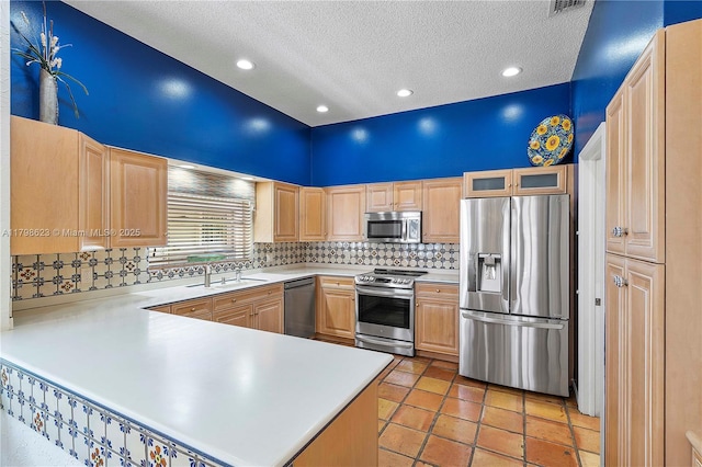 5425 NW 86th Ter, Coral Springs, FL 33067 - kitchen featuring appliances with stainless steel finishes, light brown cabinetry, a textured ceiling, light countertops, and a sink