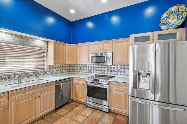 5425 NW 86th Ter, Coral Springs, FL 33067 - kitchen featuring stainless steel appliances, a sink, light countertops, light brown cabinetry, and a textured ceiling