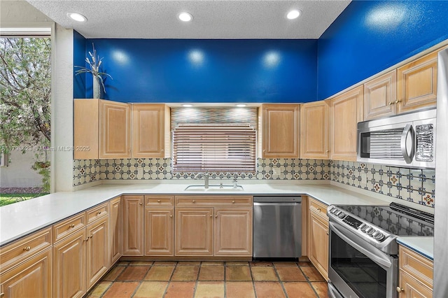 5425 NW 86th Ter, Coral Springs, FL 33067 - kitchen with appliances with stainless steel finishes, a sink, light brown cabinetry, decorative backsplash, and a textured ceiling