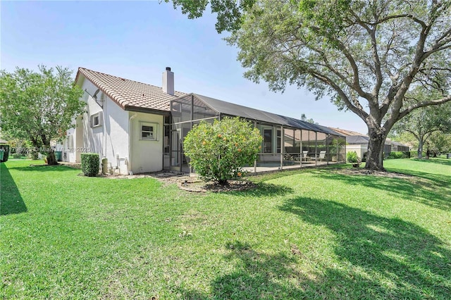 5425 NW 86th Ter, Coral Springs, FL 33067 - rear view of house with a chimney, a lawn, a tiled roof, stucco siding, and a lanai