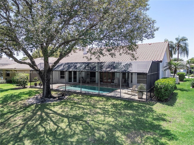 5425 NW 86th Ter, Coral Springs, FL 33067 - rear view of house with a patio area, a tiled roof, an outdoor pool, and a lawn