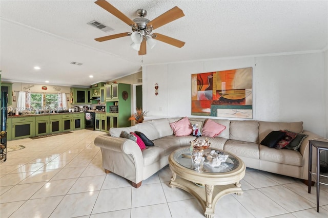 260 Taft Blvd, Clewiston, FL 33440 - living area with light tile patterned floors, ornamental molding, a ceiling fan, and lofted ceiling