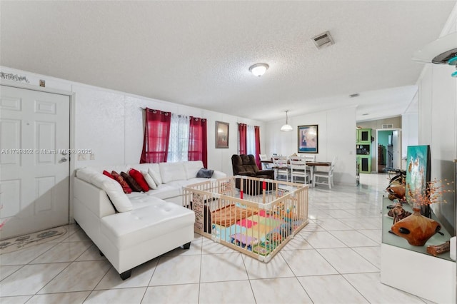 260 Taft Blvd, Clewiston, FL 33440 - living room featuring a textured ceiling and light tile patterned floors