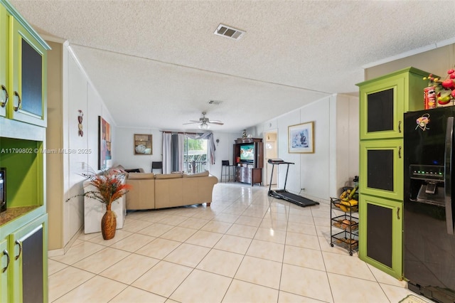260 Taft Blvd, Clewiston, FL 33440 - living room with light tile patterned floors, a textured ceiling, ceiling fan, and ornamental molding