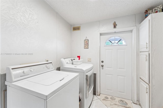 260 Taft Blvd, Clewiston, FL 33440 - washroom featuring washing machine and dryer, a textured ceiling, cabinet space, and light tile patterned flooring