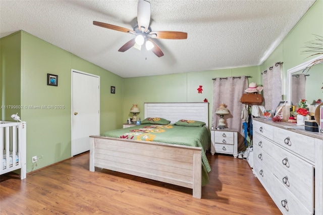 260 Taft Blvd, Clewiston, FL 33440 - bedroom with a textured ceiling, wood finished floors, vaulted ceiling, and ceiling fan