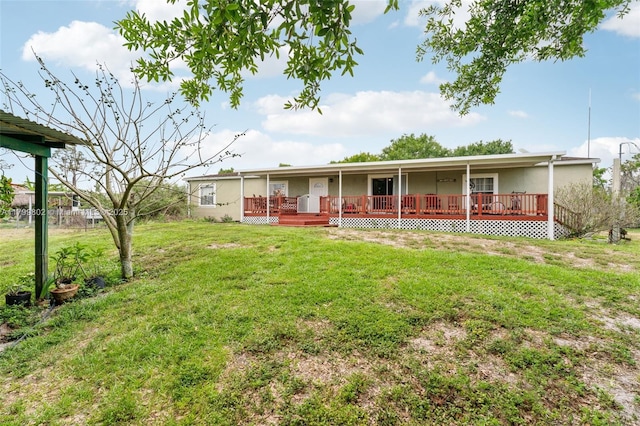 260 Taft Blvd, Clewiston, FL 33440 - view of front facade featuring a front yard, a wooden deck, and stucco siding