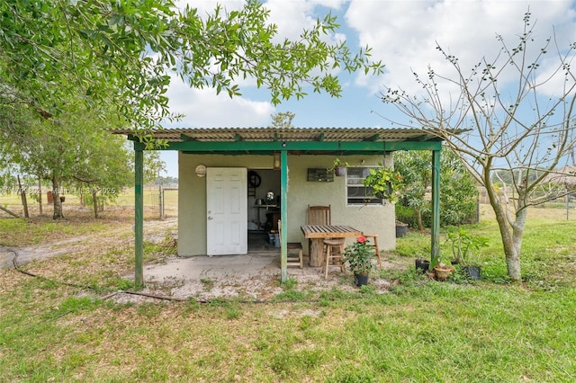 260 Taft Blvd, Clewiston, FL 33440 - back of house featuring stucco siding and a yard