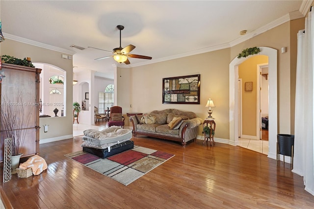 19106 Cormorant Cove Pl, Tampa, FL 33647 - living room featuring arched walkways, hardwood / wood-style floors, a ceiling fan, ornamental molding, and baseboards