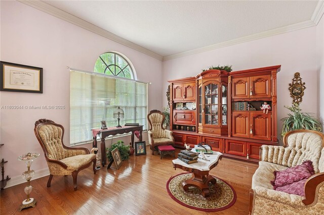 19106 Cormorant Cove Pl, Tampa, FL 33647 - sitting room featuring light wood-style floors, crown molding, and baseboards