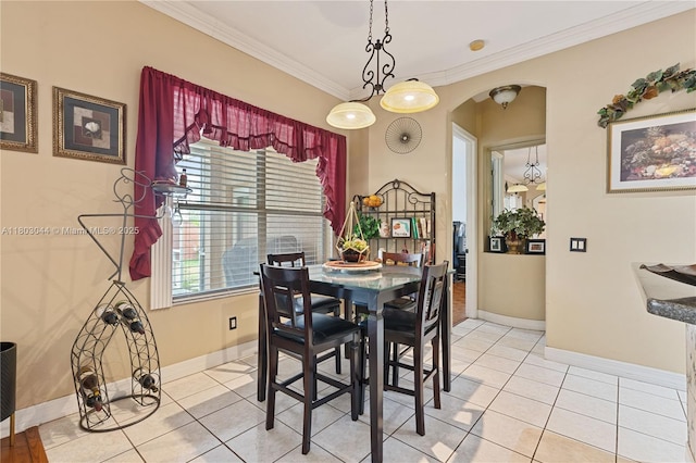 19106 Cormorant Cove Pl, Tampa, FL 33647 - dining area with arched walkways, crown molding, light tile patterned flooring, and baseboards