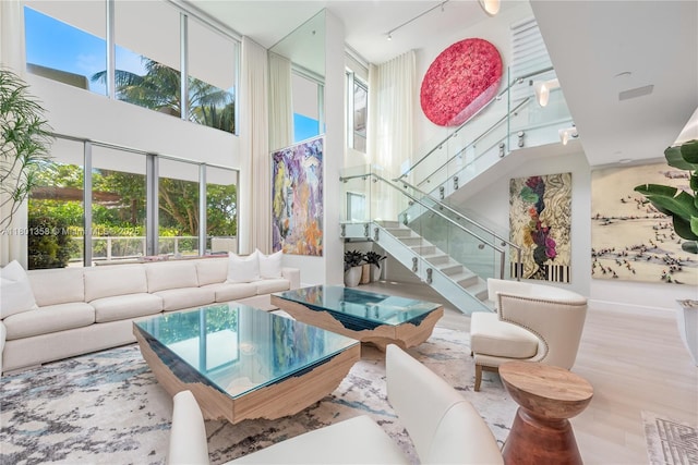 125 Ocean Dr Unit U-0203, Miami Beach, FL 33139 - living area with a towering ceiling, stairway, and wood finished floors