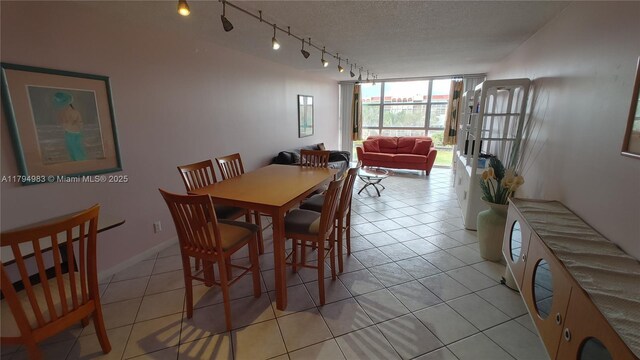 2101 Atlantic Shores Blvd Unit 415, Hallandale Beach, FL 33009 - dining space featuring light tile patterned flooring, a textured ceiling, and track lighting