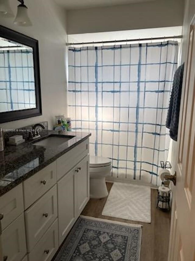 1431 Felton St, Deltona, FL 32725 - full bath with wood finished floors, toilet, vanity, and curtained shower