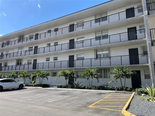 14155 SW 87th St Unit E110, Miami, FL 33183 - view of building exterior featuring uncovered parking
