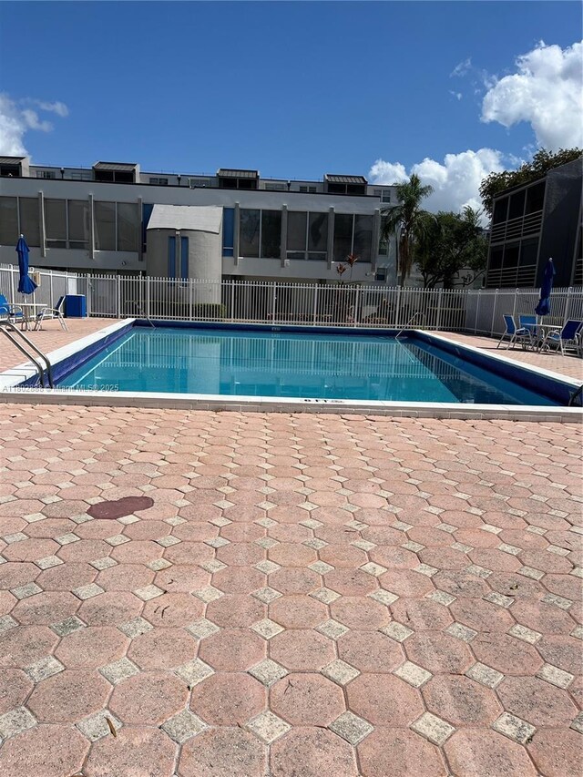 14155 SW 87th St Unit E110, Miami, FL 33183 - community pool with a patio area and fence