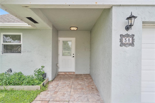 entrance to property with stucco siding