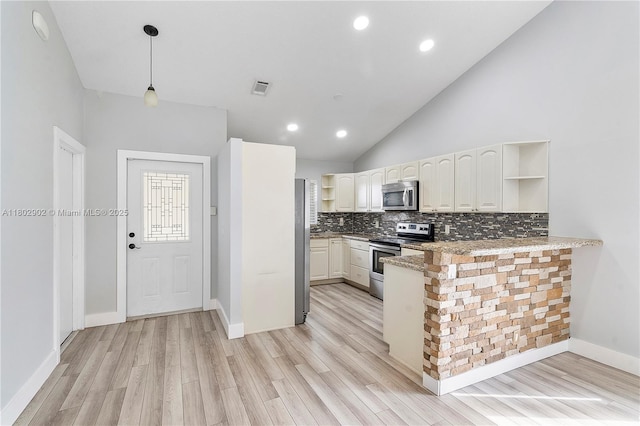 kitchen with appliances with stainless steel finishes, open shelves, a peninsula, backsplash, and light wood-type flooring