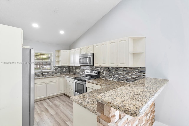 kitchen featuring open shelves, stainless steel appliances, a peninsula, a sink, and vaulted ceiling