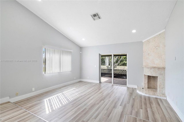 unfurnished living room with light wood-type flooring, baseboards, recessed lighting, a fireplace, and lofted ceiling