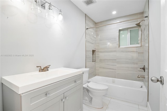 bathroom featuring toilet, tile patterned floors, vanity, and shower / washtub combination