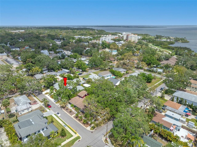aerial view of property and surrounding area with a nearby body of water and nearby suburban area