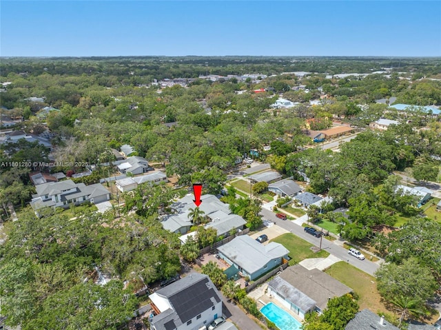view of property location with nearby suburban area and a pool