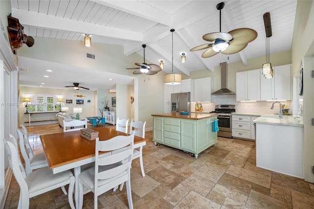 dining area featuring a ceiling fan, stone tile floors, and recessed lighting