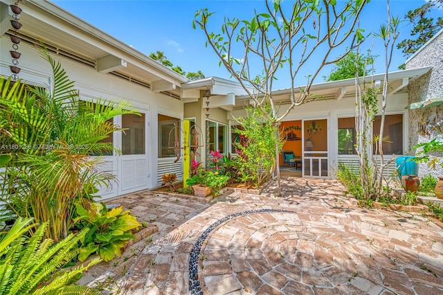 view of patio with a sunroom