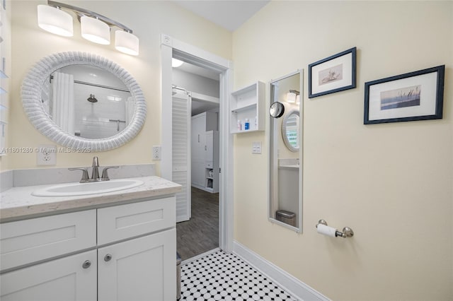bathroom with baseboards, vanity, and a shower with shower curtain