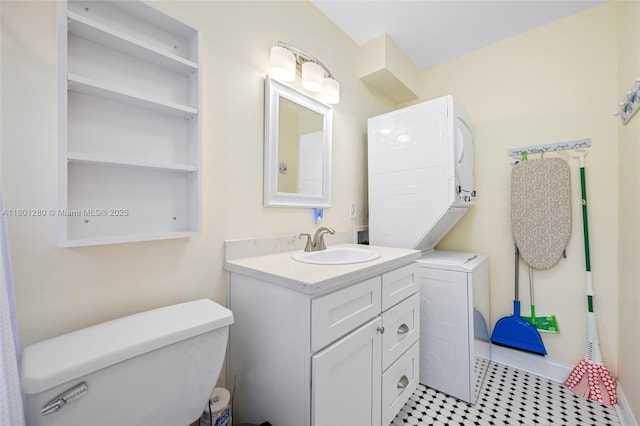 bathroom with toilet, vanity, and baseboards